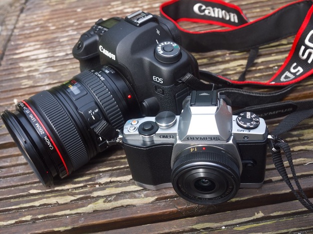 Olympus OM-D EM-5 with 14MM Lumix lens beside Canon's semi pro 5DMKii with 24-105 lens.